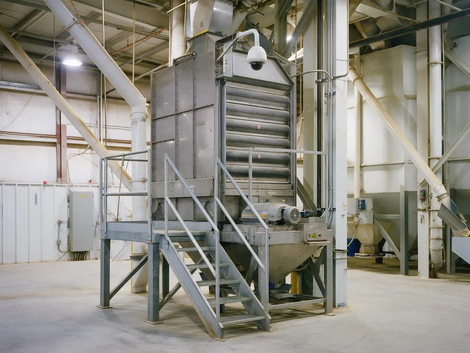 A pellet cooler with a steel stair inside a feed mill